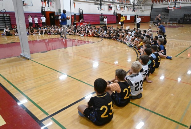 Former Warriors player Adonal Foyle speaks to kids during their...