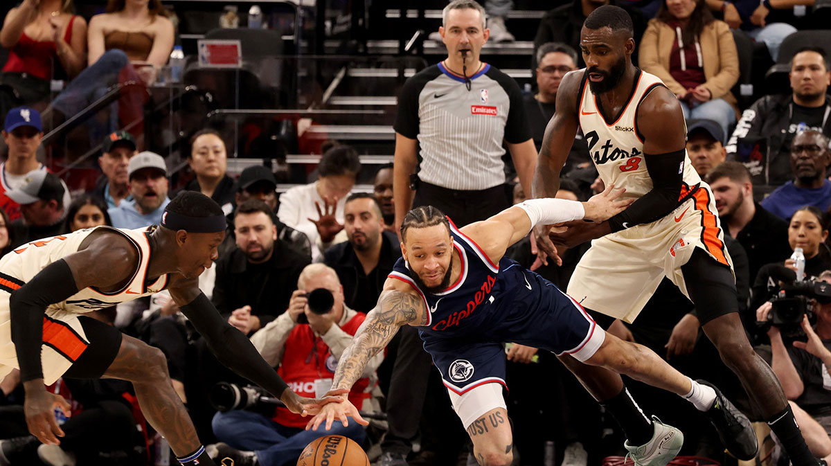 LA Clippers guard Amir Coffey (7) fights for a loose ball against Detroit Pistons guard Dennis Schroder (17) and forward Tim Hardaway Jr. (8) during the third quarter at Intuit Dome. 