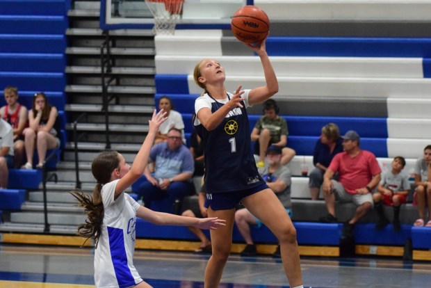 Cabrini's Madisyn Smith, #1 in blue, goes up for a...