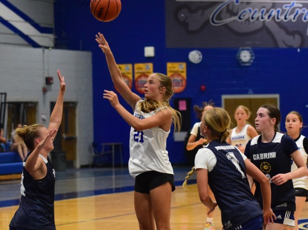Carlson's Jillian Farago, #21 in white, puts up a shot...