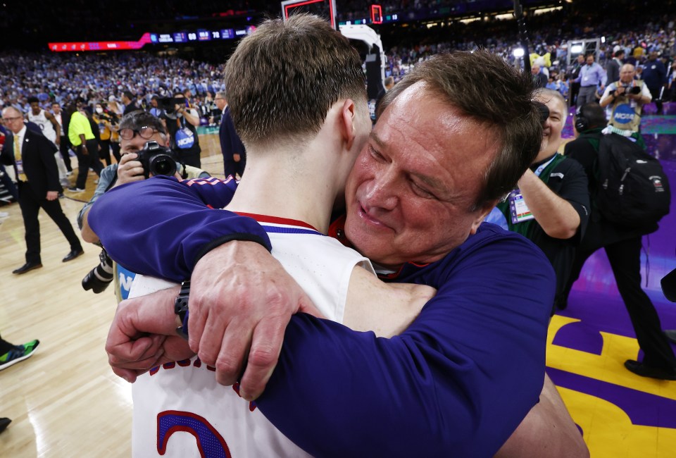 Kansas Jayhawks coach Bill Self hugging player Christian Braun after winning the NCAA Men's Basketball Championship.