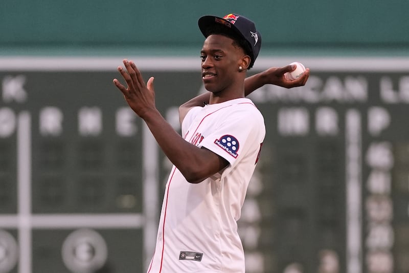 AJ Dybantsa Jr., of Brockton, Mass., a top-rated high school basketball player who will play for BYU, throws out the ceremonial first pitch prior to a game between the Boston Red Sox and Tampa Bay Rays at Fenway Park, Thursday, July 10, 2025, in Boston.
