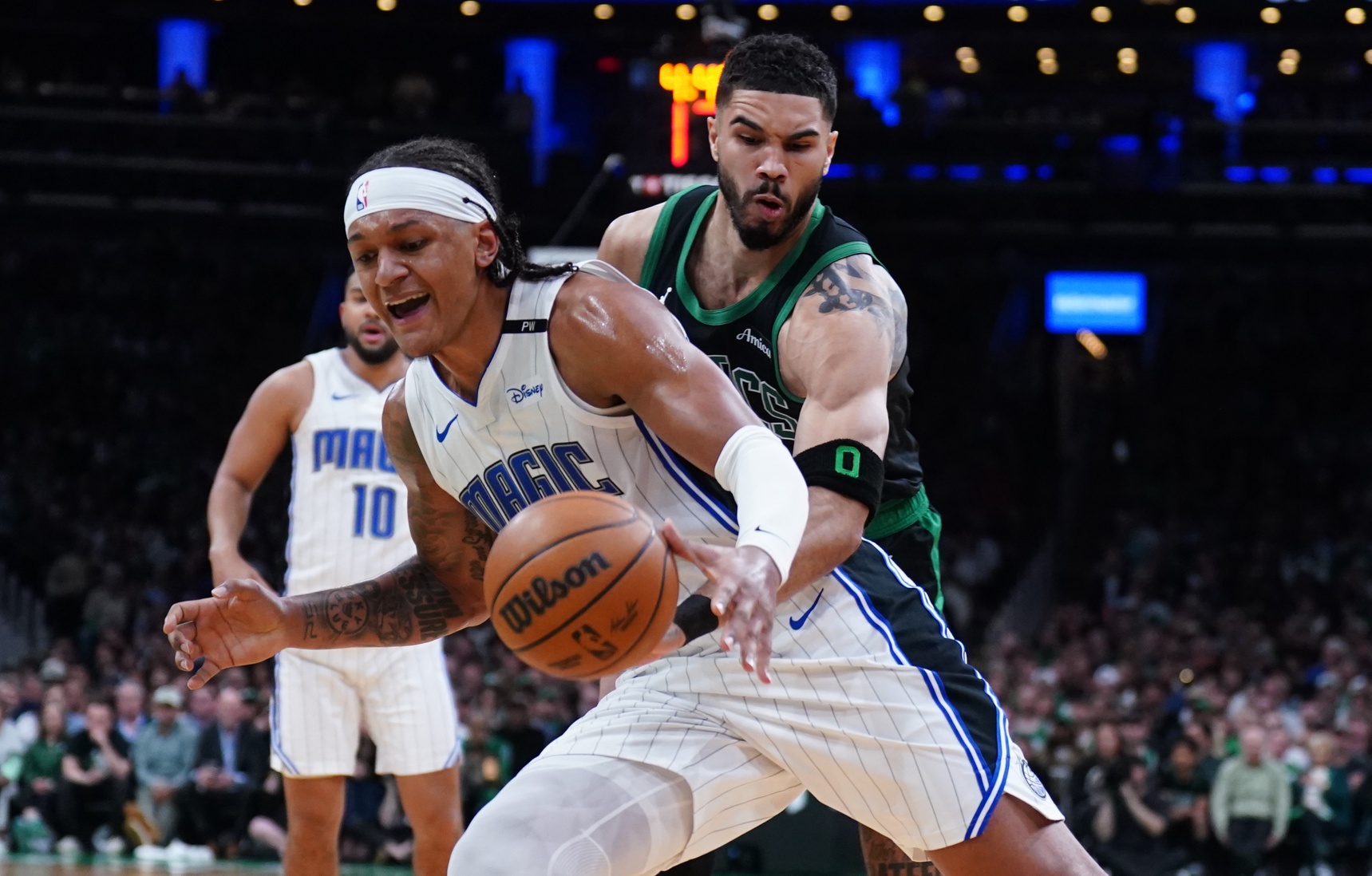 Boston Celtics forward Jayson Tatum (0) defends against Orlando Magic forward Paolo Banchero (5) in the second quarter during game five of first round for the 2025 NBA Playoffs at TD Garden.