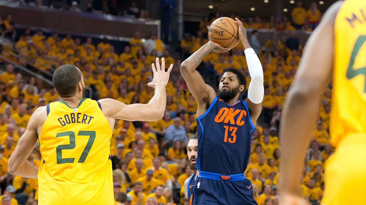 Oklahoma City Thunder forward Paul George (13) shoots the ball against Utah Jazz center Rudy Gobert (27) during the first quarter of game six of the first round of the 2018 NBA Playoffs at Vivint Smart Home Arena.