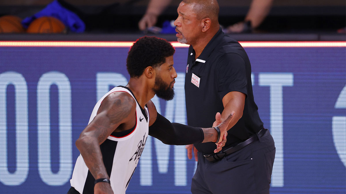 Doc Rivers of the LA Clippers celebrates with Paul George #13 after a win against the Dallas Mavericks during the second half in a NBA basketball first round playoff game at AdventHealth Arena.
