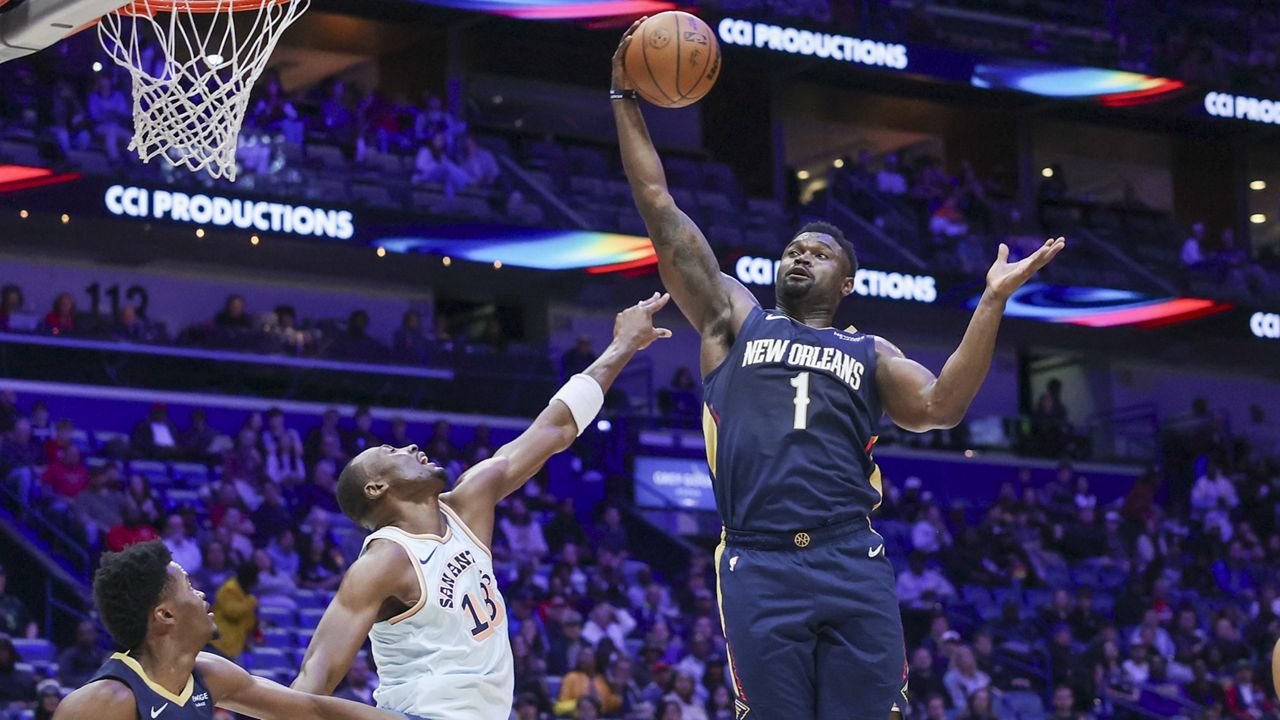 New Orleans Pelicans forward Zion Williamson (1) pulls down a defensive rebound against San Antonio Spurs center Bismack Biyombo (18) in the first half of an NBA basketball game in New Orleans, Sunday, Feb. 23, 2025. (AP Photo/Peter Forest)