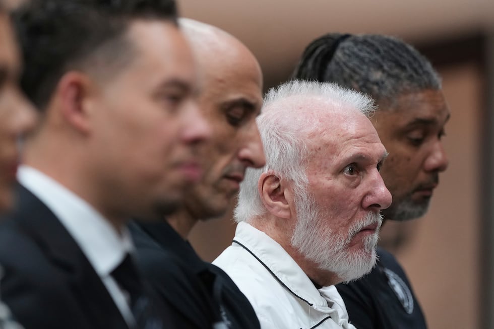 Former San Antonio Spurs head coach Gregg Popovich, second from right, sits between former...