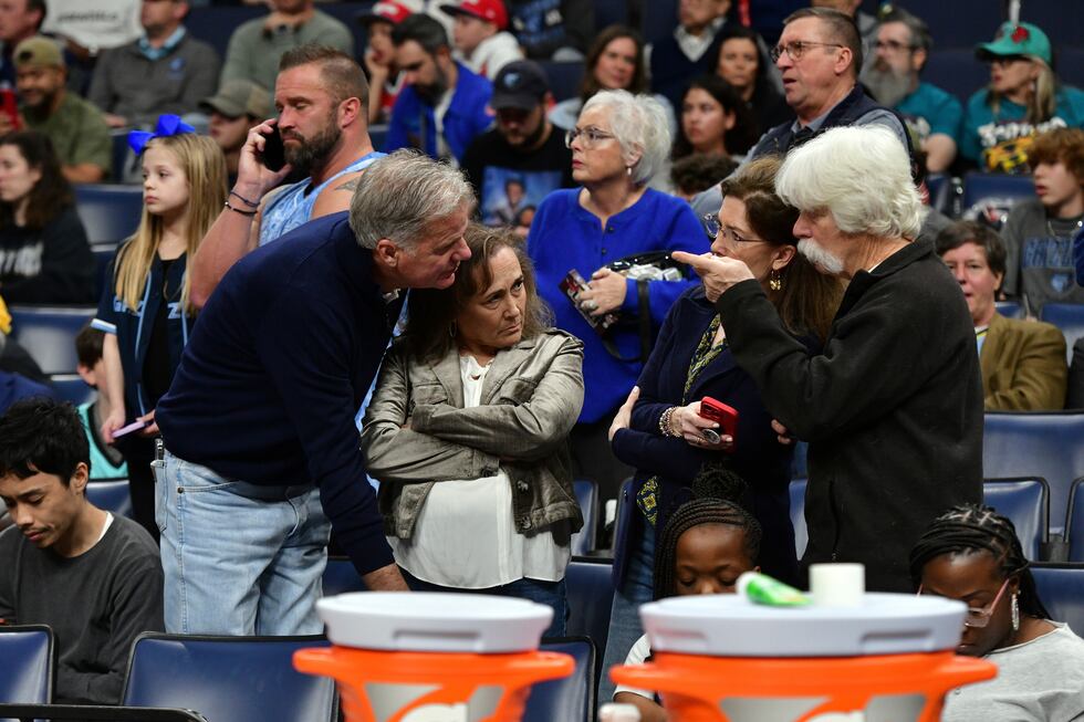 Fans react after a man suffered a medical emergency courtside just before the start of an NBA...