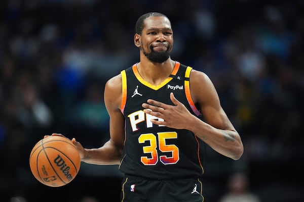 FILE - Phoenix Suns forward Kevin Durant gestures during the second half of an NBA basketball game on March 9, 2025, in Dallas. (AP Photo/Julio Cortez, File)