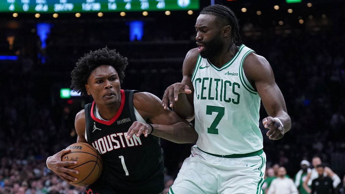 Houston Rockets forward Amen Thompson (1) drives the ball to the basket against Boston Celtics guard Jaylen Brown (7) in the last seconds of then game at TD Garden.
