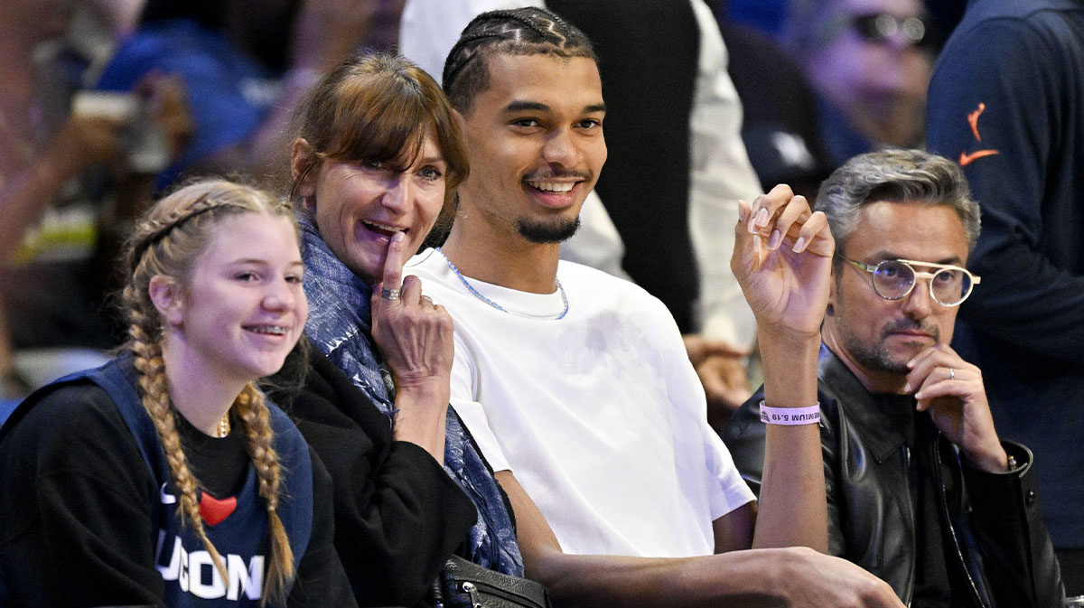Spurs forward Victor Wembanyama and his mother Elodie de Fautereau watch the game between the Dallas Wings and the Seattle Storm during the first half at College Park Center