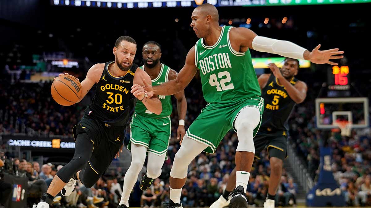 Golden State Warriors guard Stephen Curry (30) dribbles the ball next to Boston Celtics center Al Horford (42) in the third quarter at the Chase Center. 