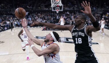 Phoenix Suns guard Devin Booker (1) is defended by San Antonio Spurs center Bismack Biyombo (18) as he tries to score during the second half of an NBA basketball game in Austin, Texas, Thursday, Feb. 20, 2025. (AP Photo/Eric Gay)