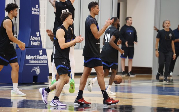 Orlando Magic players gather during practice at the AdventHealth Training...