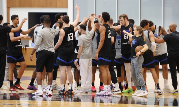 Orlando Magic players gather during practice at the AdventHealth Training...