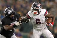 Denton Ryan running back Anthony Hill Jr. (6), right, tries to elude College Station...