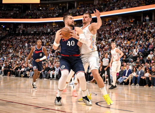 Nikola Jokic (15) of the Denver Nuggets defends Ivica Zubac...