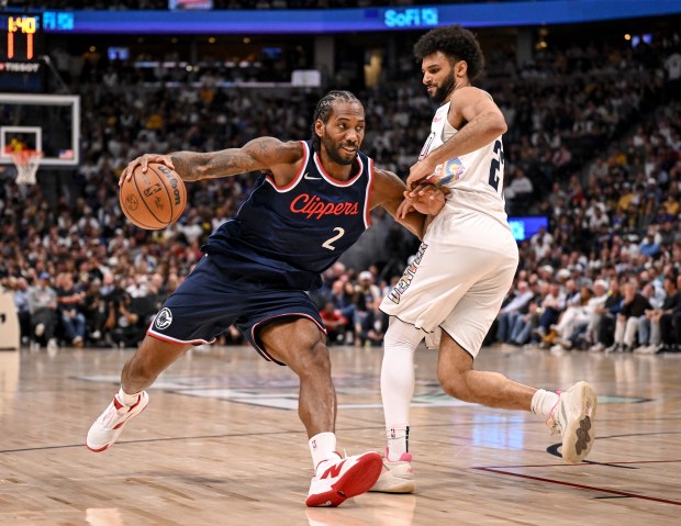 Jamal Murray (27) of the Denver Nuggets defends Kawhi Leonard...