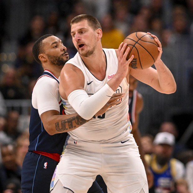Nikola Jokic (15) of the Denver Nuggets works as Norman...