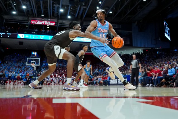 Dayton forward DaRon Holmes II (15) dribbles the ball against St. Bonaventure center Noel Brown (20) during an NCAA college basketball game, Friday, Feb. 2, 2024, in Dayton, Ohio. (AP Photo/Aaron Doster)