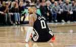 FILE-Milwaukee Bucks' Damian Lillard grimaces as he falls to the floor against the Indiana Pacers during the first half of Game 4 of a first-round NBA basketball playoff series Sunday, April 27, 2025, in Milwaukee.