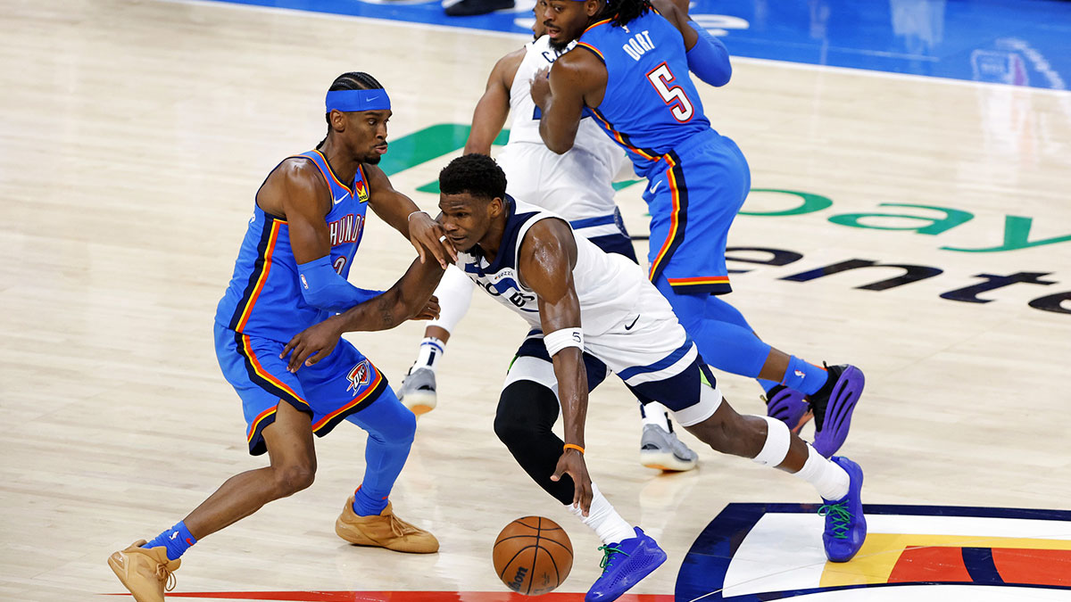 Timberwolves guard Anthony Edwards (5) drives to the basket against Oklahoma City Thunder guard Shai Gilgeous-Alexander (2) in game five of the western conference finals for the 2025 NBA Playoffs at Paycom Center