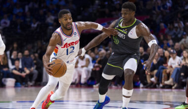 Philadelphia 76ers' Jared Butler, left, drives to the basket against Minnesota Timberwolves' Anthon...