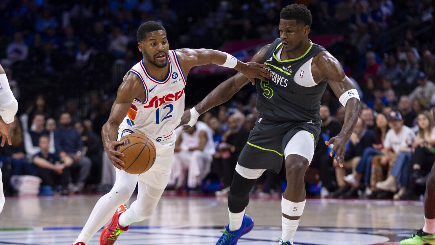 Philadelphia 76ers' Jared Butler, left, drives to the basket against Minnesota Timberwolves' Anthon...