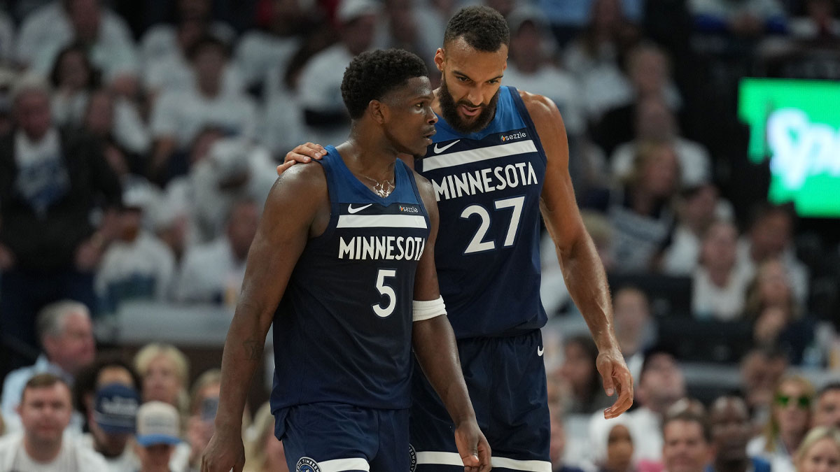 Minnesota Timberwolves guard Anthony Edwards (5) and center Rudy Gobert (27) talk against the Oklahoma City Thunder in the first half during game four of the western conference finals for the 2025 NBA Playoffs at Target Center.