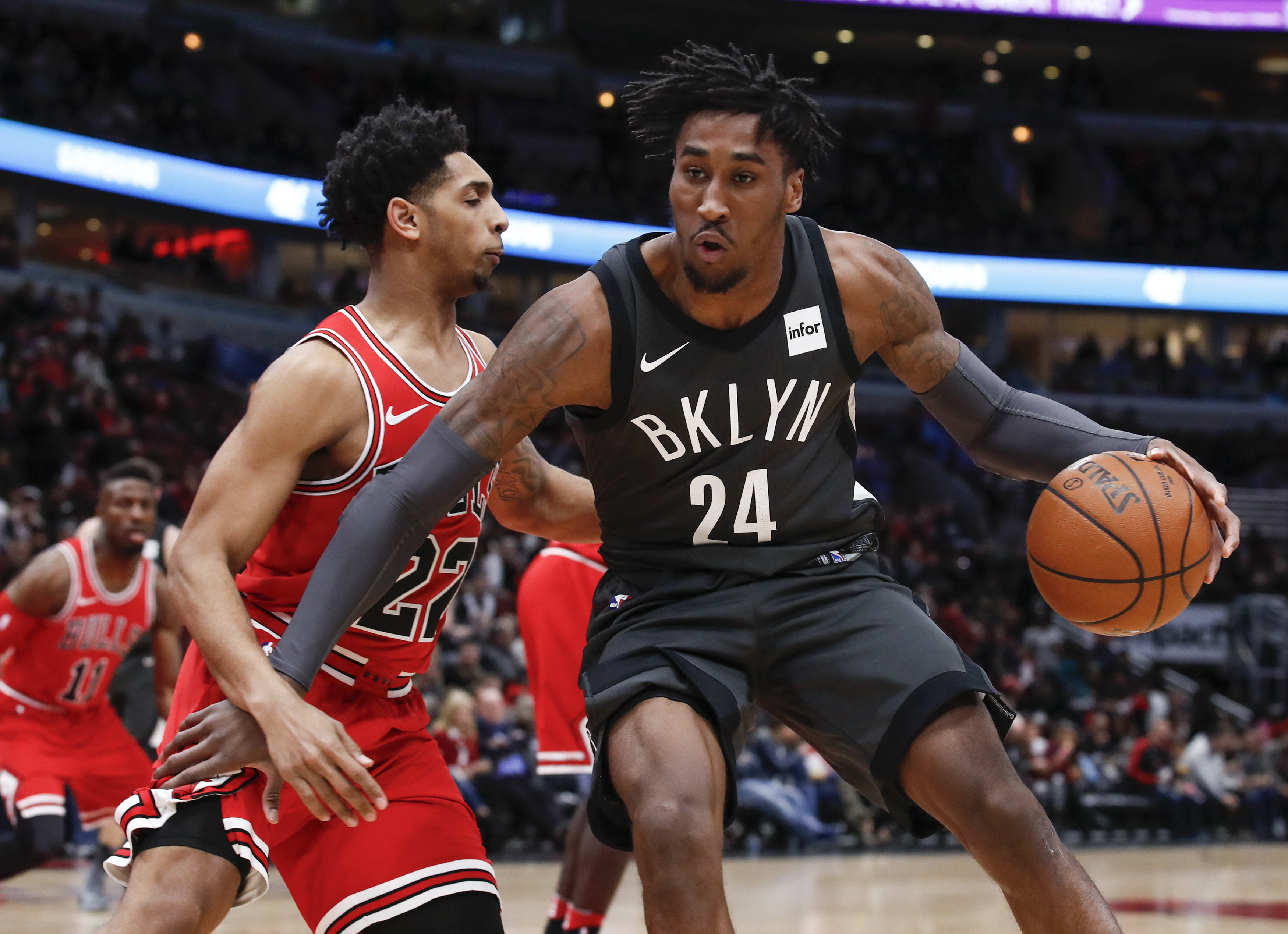 Brooklyn Nets forward Rondae Hollis-Jefferson (24) is defended by Chicago Bulls guard Cameron Payne (22) during the first half at United Center.