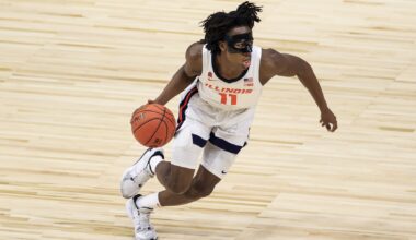 Illinois Fighting Illini guard Ayo Dosunmu (11) controls the ball in the game against the Rutgers Scarlet Knights in the first half at Lucas Oil Stadium.