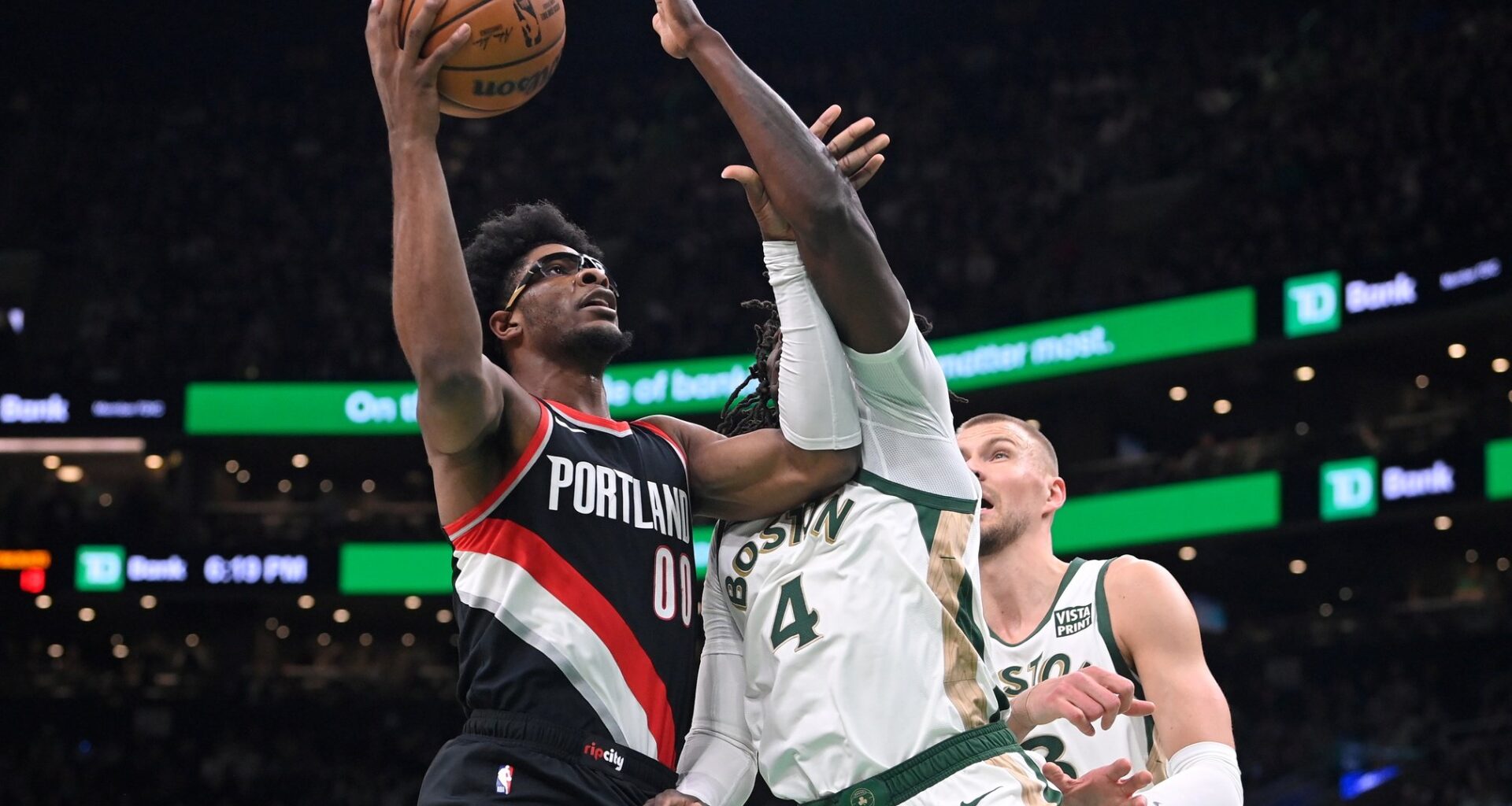 Portland Trail Blazers guard Scoot Henderson (00) shoots the ball against Boston Celtics guard Jrue Holiday (4) during the first half at TD Garden.
