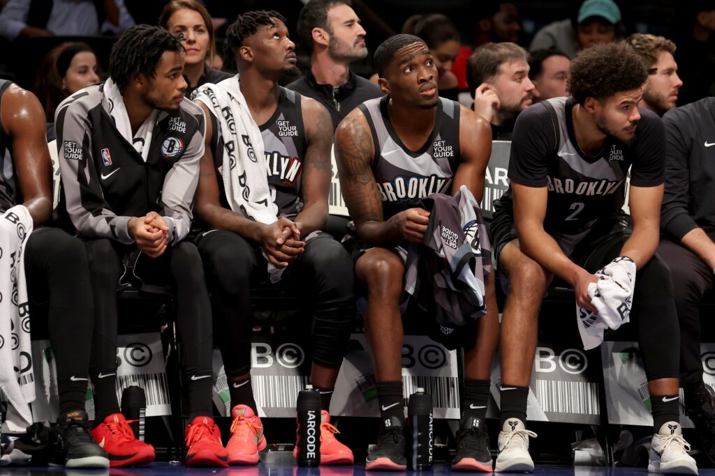 Brooklyn Nets center Nic Claxton (33) and forward Dorian Finney-Smith (28) and guard Shake Milton (7) and forward Cameron Johnson (2) watch from the bench during the fourth quarter against the Cleveland Cavaliers at Barclays Center.