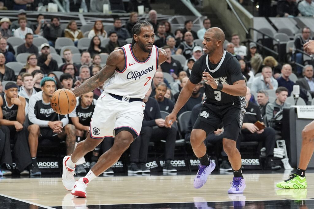 Jan 29, 2025; San Antonio, Texas, USA; LA Clippers forward Kawhi Leonard (2) dribbles against San Antonio Spurs guard Chris Paul (3) in the first half at Frost Bank Center. Mandatory Credit: Daniel Dunn-Imagn Images