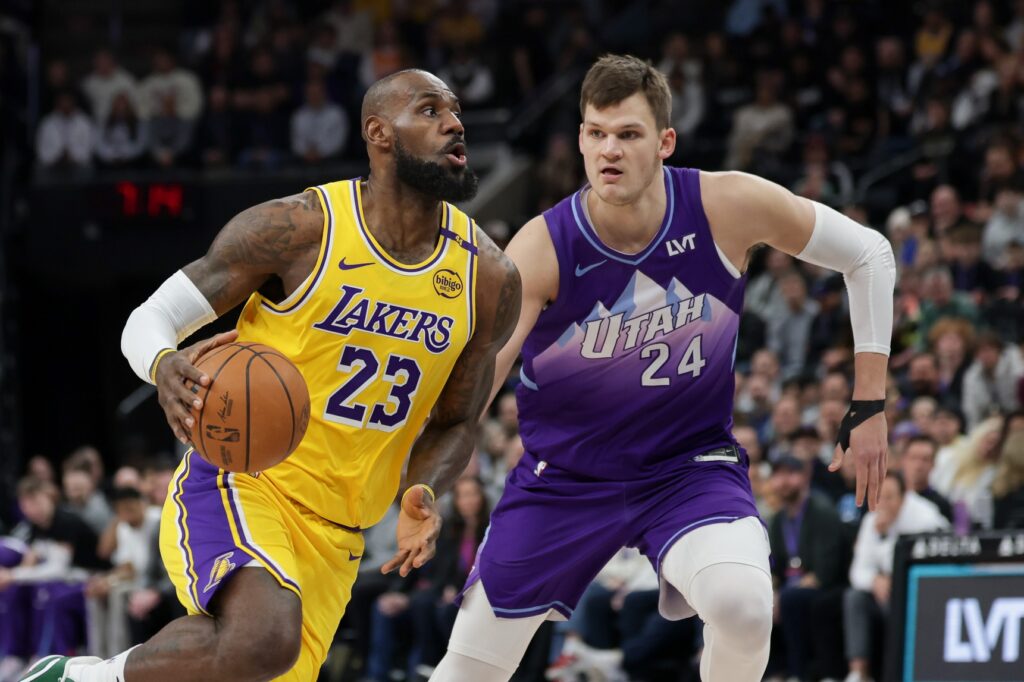 Feb 12, 2025; Salt Lake City, Utah, USA; Los Angeles Lakers forward LeBron James (23) dribbles past Utah Jazz center Walker Kessler (24) during the first quarter at Delta Center. Mandatory Credit: Chris Nicoll-Imagn Images