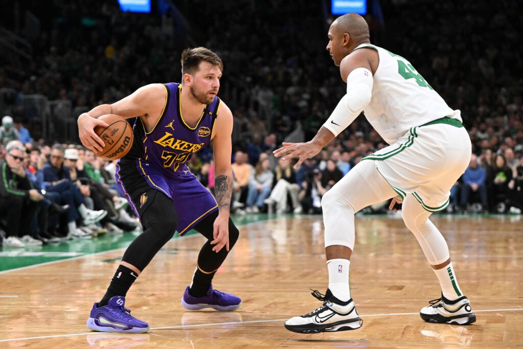 Mar 8, 2025; Boston, Massachusetts, USA; Los Angeles Lakers guard Luka Doncic (77) drives to the basket against Boston Celtics center Al Horford (42) during the second quarter at the TD Garden. Mandatory Credit: Brian Fluharty-Imagn Images
