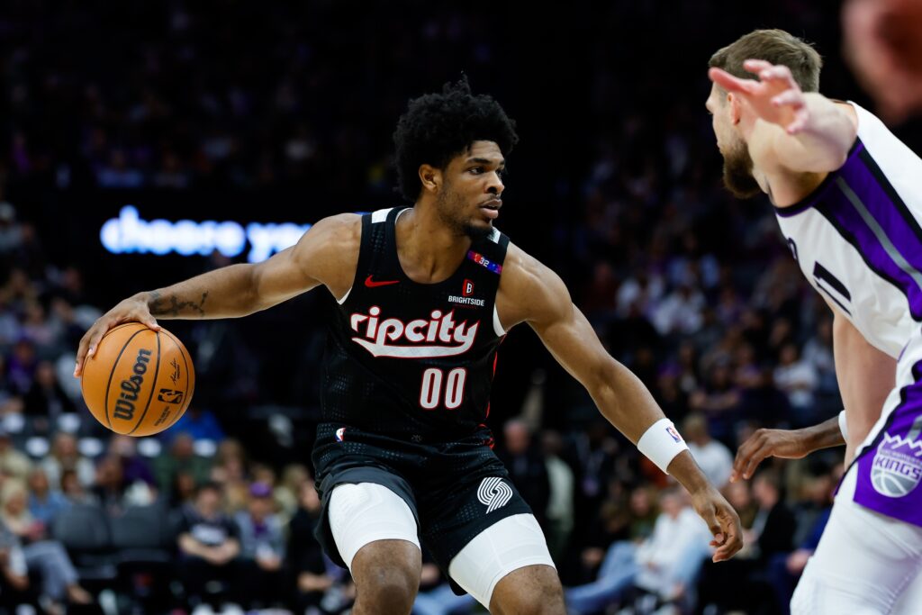 Portland Trail Blazers guard Scoot Henderson (00) dribbles against Sacramento Kings forward Domantas Sabonis (11) during the third quarter at Golden 1 Center. 