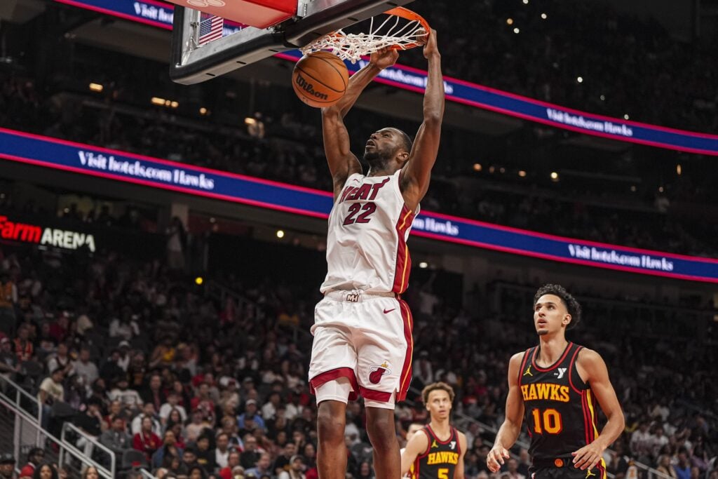 Apr 18, 2025; Atlanta, Georgia, USA; Miami Heat forward Andrew Wiggins (22) dunks behind Atlanta Hawks forward Zaccharie Risacher (10) during the second half at State Farm Arena. Mandatory Credit: Dale Zanine-Imagn Images