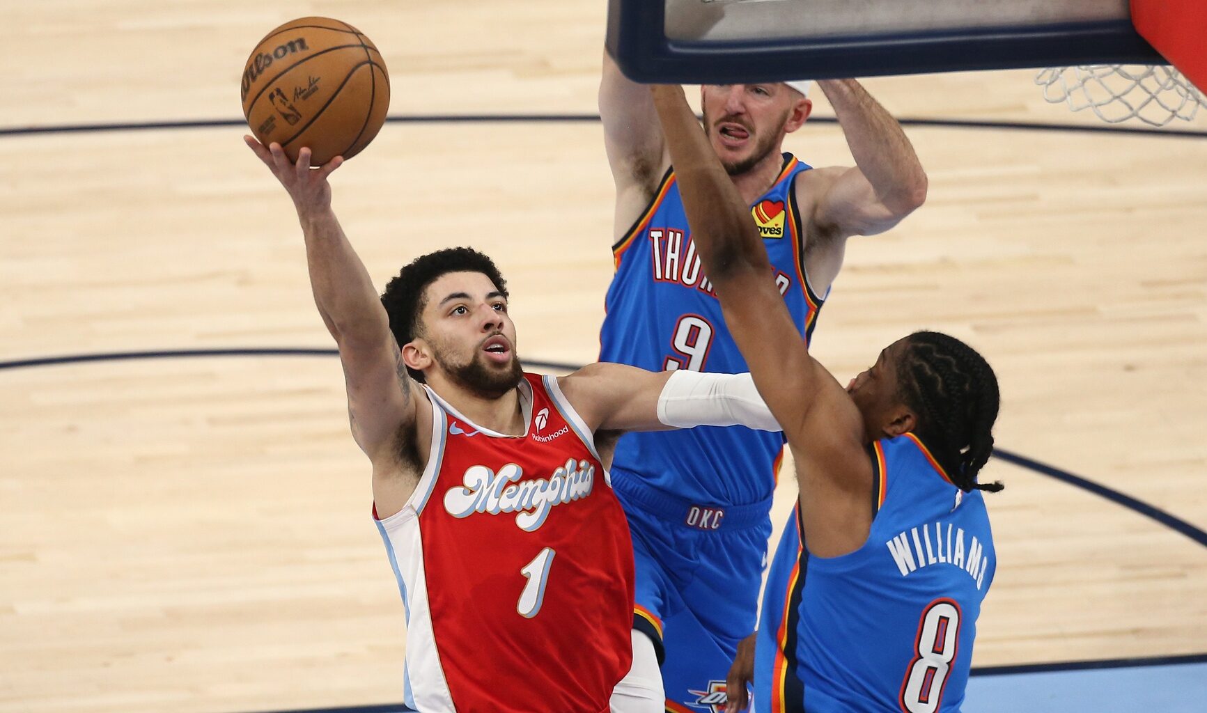 Apr 26, 2025; Memphis, Tennessee, USA; Memphis Grizzlies guard Scotty Pippen Jr. (1) shoots as Oklahoma City Thunder forward Jalen Williams (8) defends during the second quarter during game four for the first round of the 2024 NBA Playoffs at FedExForum. Mandatory Credit: Petre Thomas-Imagn Images