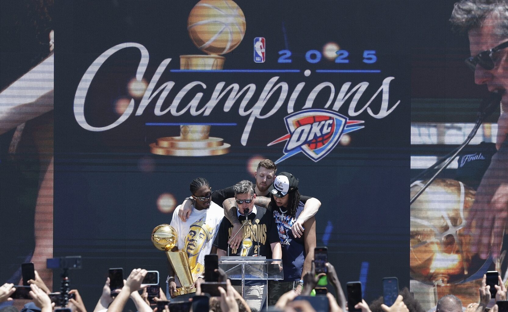 Jun 24, 2025; Oklahoma City, OK, USA; Oklahoma City Thunder forward Jalen Williams, left, Oklahoma City Thunder center Isaiah Hartenstein, back, and Oklahoma City Thunder forward Jaylin Williams, right, gather around Oklahoma City Mayor David Holt during the Oklahoma City Thunder Champions parade closing ceremony at Scissortail Park. Mandatory Credit: Alonzo Adams-Imagn Images
