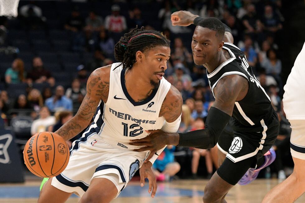 Memphis Grizzlies guard Ja Morant (12) handles the ball against Brooklyn Nets guard Dennis...