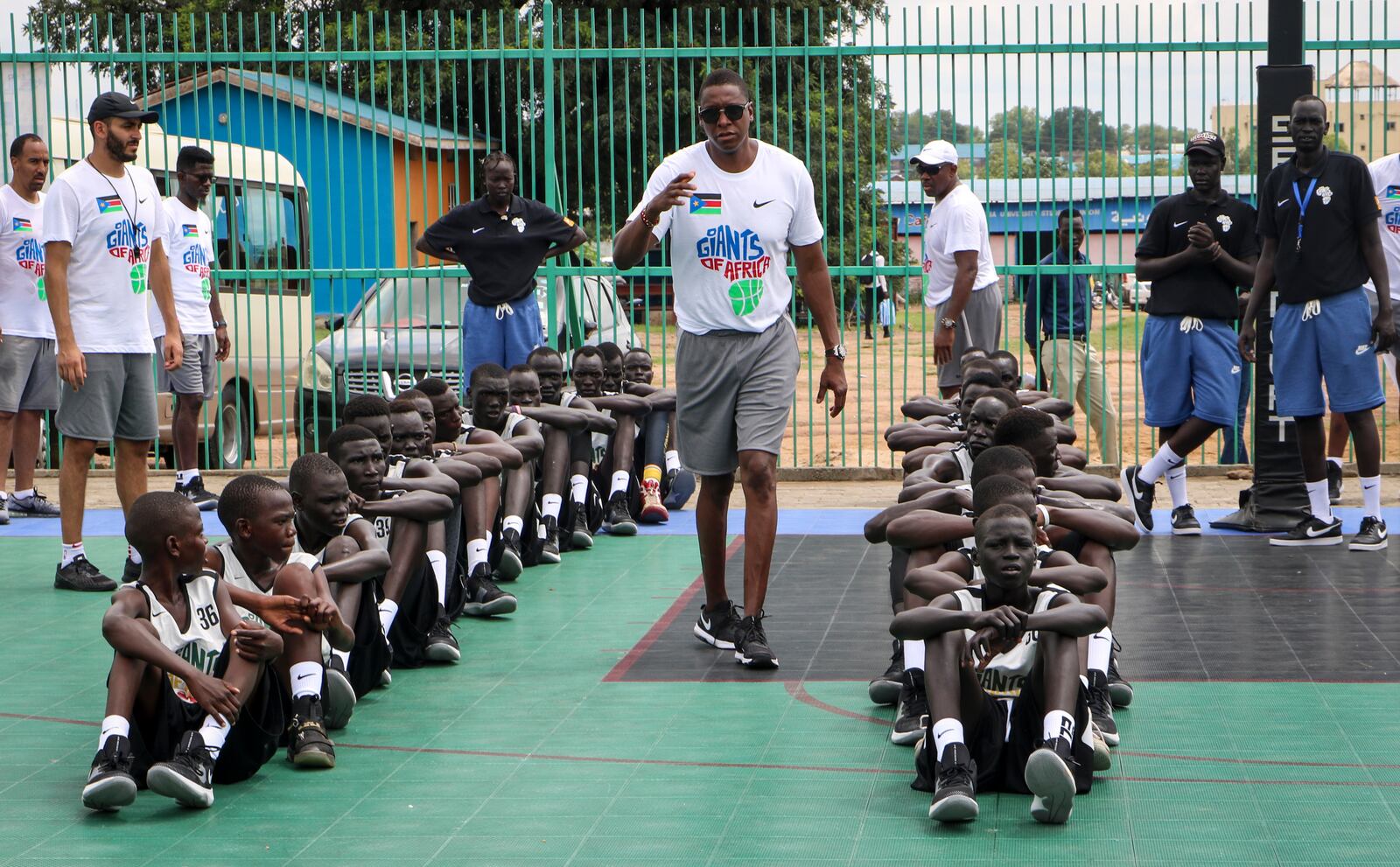 FILE - Masai Ujiri walks between rows of youth players on the basketball court during a three-day basketball training camp run by Giants of Africa in Juba, South Sudan, Aug. 20, 2019. (AP Photo/Sam Mednick, File)