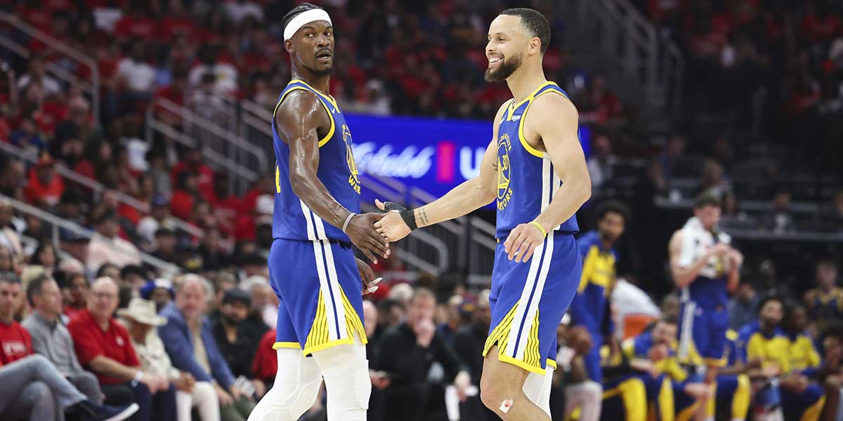 Warriors guard Stephen Curry (30) celebrates with forward Jimmy Butler III (10) after a play during the second quarter against the Houston Rockets at Toyota Center
