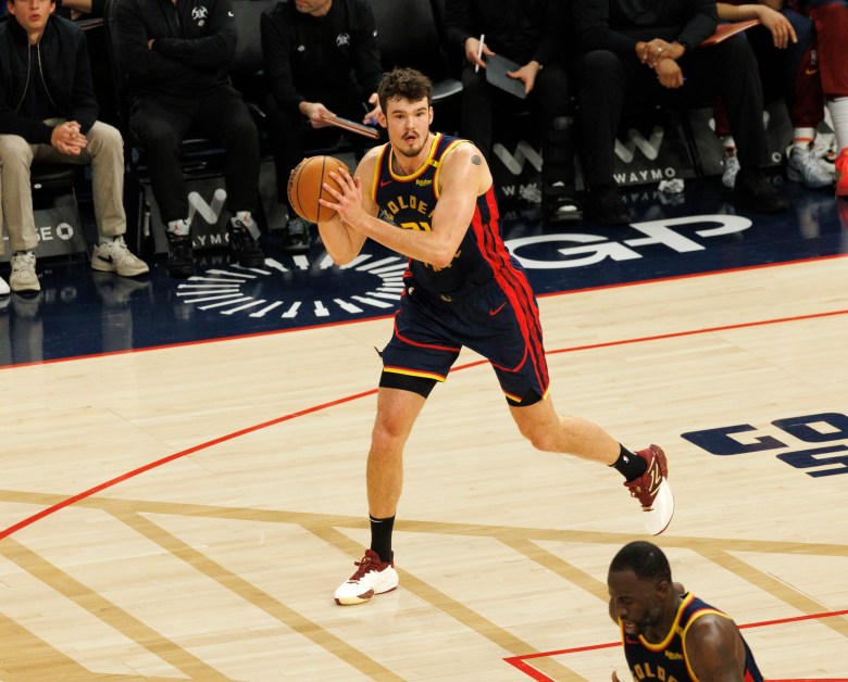 Quinten Post jogs up court with Draymond Green.