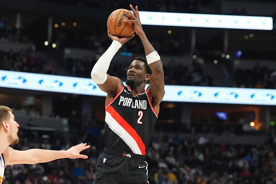 Portland Trail Blazers center Deandre Ayton shoots under pressure from Denver Nuggets center Nikola Jokic.