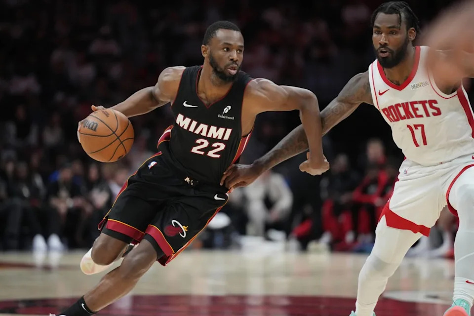 Mar 21, 2025; Miami, Florida, USA; Miami Heat forward Andrew Wiggins (22) drives past Houston Rockets forward Tari Eason (17) in the second half at Kaseya Center. Mandatory Credit: Jim Rassol-Imagn ImagesMandatory Credit: Jim Rassol-Imagn Images
