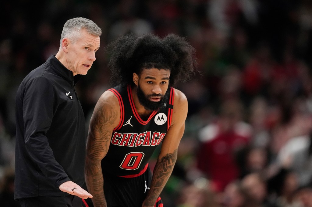 Billy Donovan talks with Coby White during the Bulls' March 13 game.