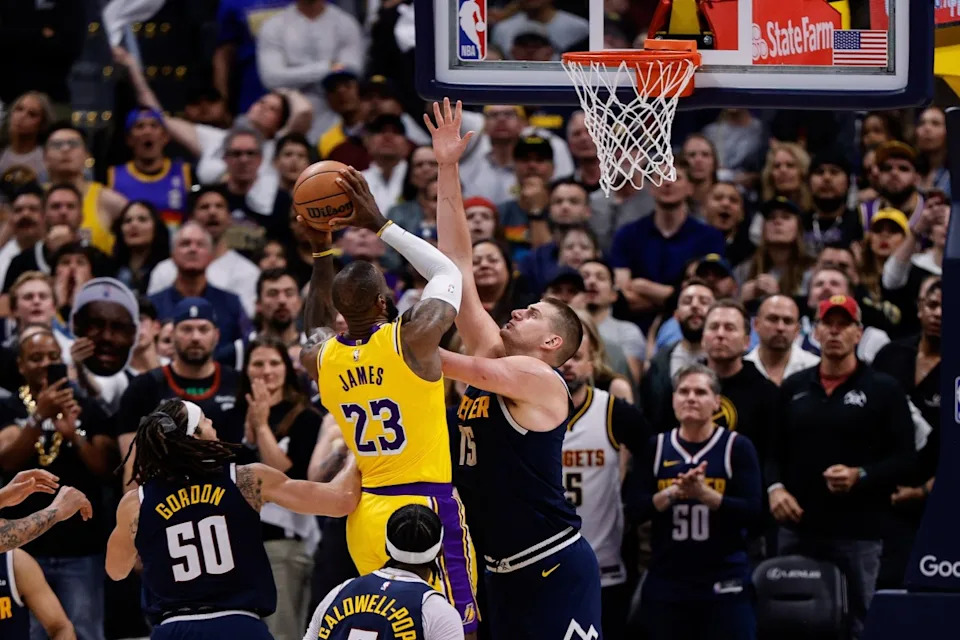 Los Angeles Lakers forward LeBron James (23) drives to the net against Denver Nuggets center Nikola Jokic (15) in the fourth quarter during game five of the first round for the 2024 NBA playoffs at Ball Arena.© Isaiah J&period; Downing-Imagn Images
