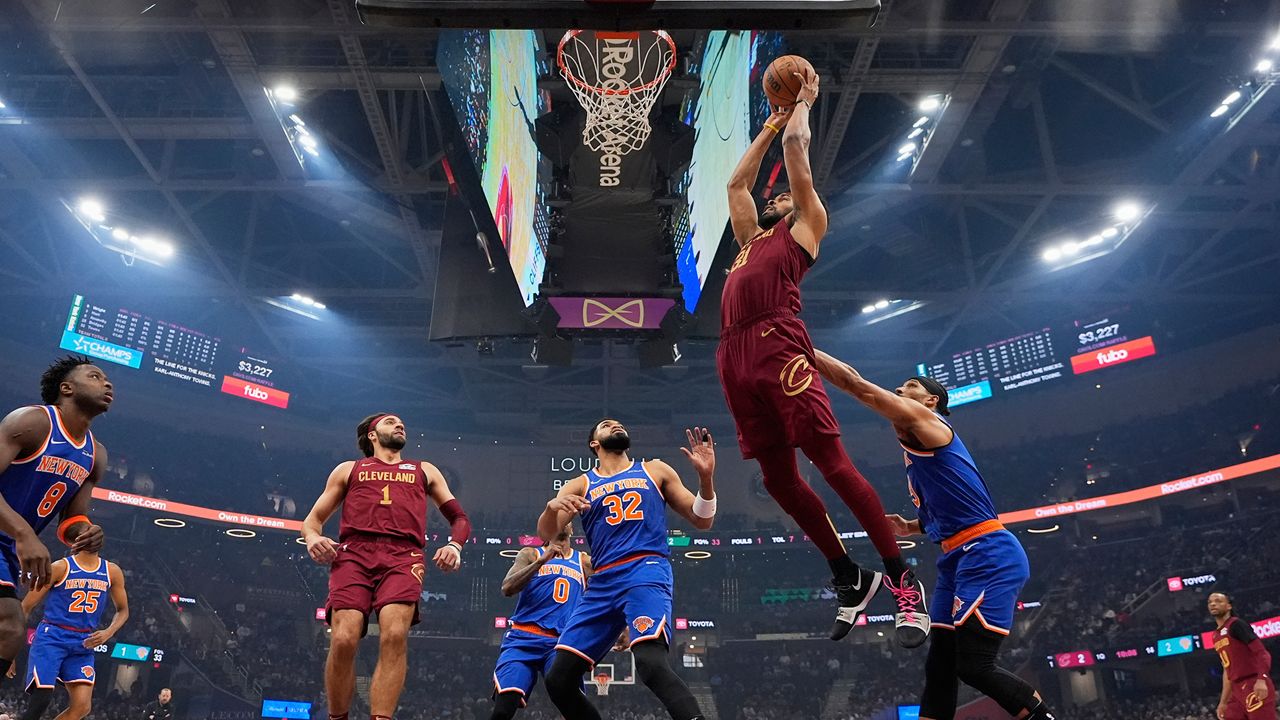 Cleveland Cavaliers center Jarrett Allen (31) goes up for a dunk in front of New York Knicks center Karl-Anthony Towns (32) in the first half of an NBA basketball game Wednesday, April 2, 2025, in Cleveland.
