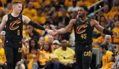Cleveland Cavaliers guard Sam Merrill (5) and guard Donovan Mitchell (45) celebrate during the second half of Game 3 in the Eastern Conference semifinals of the NBA basketball playoffs against the Indiana Pacers in Indianapolis, Friday, May 9, 2025. (AP Photo/Michael Conroy)